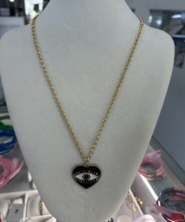 Aesthetic:  Collar en tono dorado con dije en forma de corazón y el ojo turco