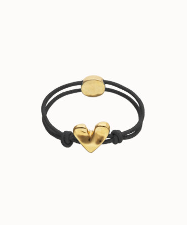 UNO DE 50: Pulsera elástica negra con corazón dorado.